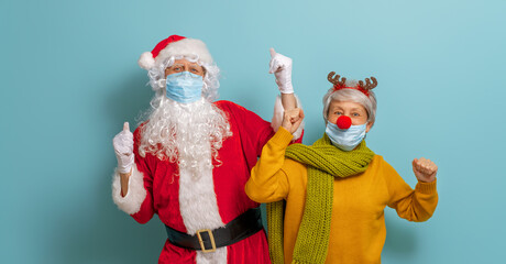 Santa Claus and reindeer in face masks during Covid-2019