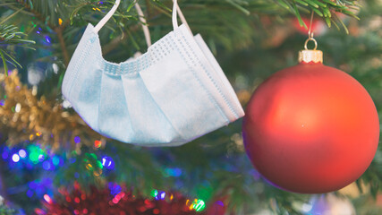Protective face mask hanging as Christmas tree decoration. 
