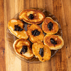 Pancakes or fritters with jam in plate on a table