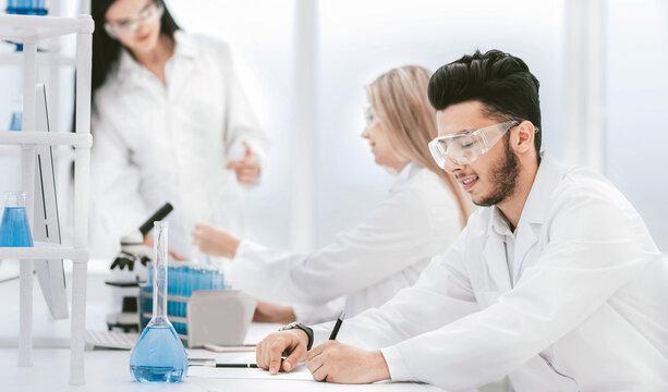 close up.young scientist sitting at his Desk in the laboratory