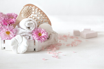 Spa composition with natural soap, a set of bath products and flowers.
