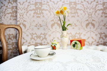 Coffee cup with vase on cafe table