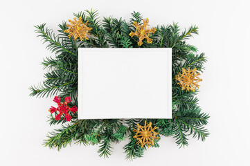 Flat lay minimal style. Christmas decoration pine branches with frame. Holidays theme photo.