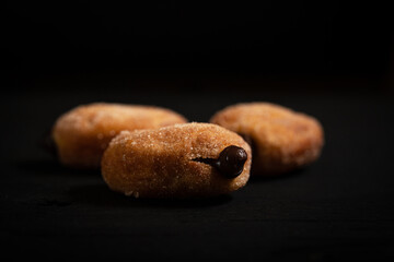 Three freshly made eclair in a black background