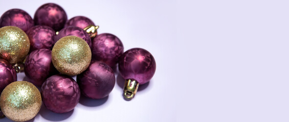 Purple and gold christmas balls on a light background