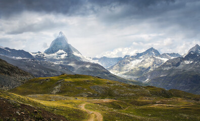 Fototapeta premium Matterhorn and its green surroundings with a spectacular sky