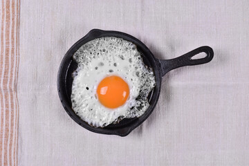 Sunny side up chicken egg in cast iron skillet 