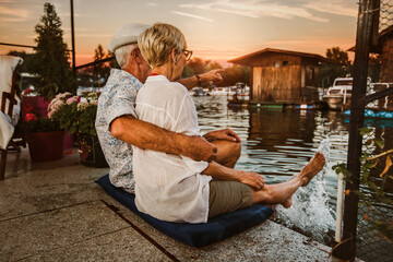 Senior couple enjoying a evening in the cottage near the river