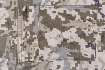 Pocket on pants of pixellated digital camouflage fabric close-up