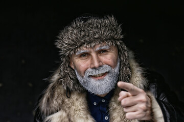 Santa Claus hipster / portrait of a fashionable modern Santa, young man with a gray beard, Christmas winter portrait