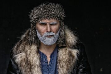 brutal man with a beard in winter clothes / portrait person with a gray beard, hipster warm clothes...