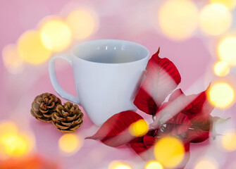 White mug and christmas decoration on a pink background.