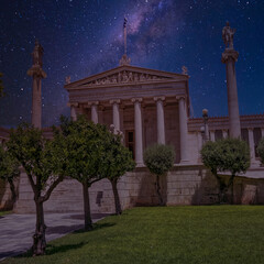 Fototapeta na wymiar The National academy of Athens classic building with Athena and Apollo statues under starry sky, Athens Greece