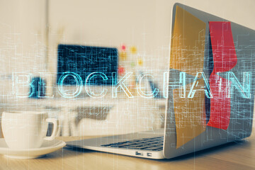 Multi exposure of blockchain and crypto economy theme hologram and table with computer background. Concept of bitcoin cryptocurrency.