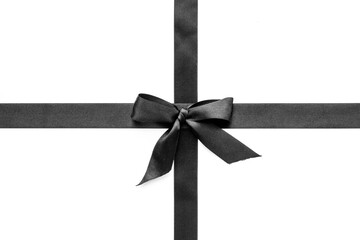 Black ribbon with bow isolated on white. Top view, copy space