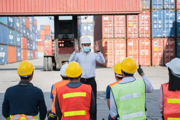 Logistics manager worker warehouse , transportation business Containers  concept .Engineering worker professional team training  a logistic or industrial warehouse.  Mask medicals protection