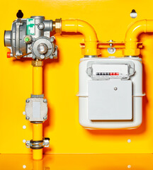 Gas meter with reducer on a yellow background.