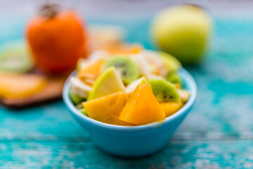 Fruit salad in a bowl on a table. Healthy and delicious diet.