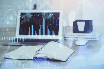 Stock market chart hologram drawn on personal computer background. Multi exposure. Concept of...