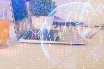 Financial graph colorful drawing and table with computer on background. Double exposure. Concept of...