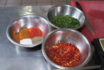 Bowls with dill, parsley, spices, salt, etc. for filling minced meat
