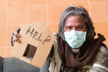A homeless man with a sign asking for help