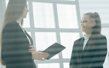 Fototapeta premium through the blinds. young employees discussing the latest news.