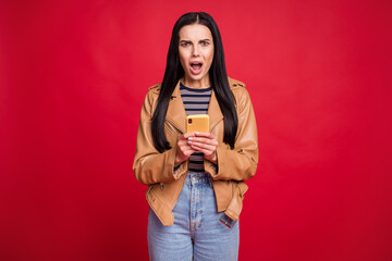 Photo of displeased lady open mouth sullen face yell unfair user dislike post isolated on red color...