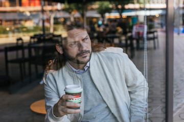 creative photography man through glass drinking coffee
