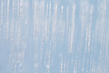 Fragment of a piece of ice. Air bubbles inside a transparent icicle.