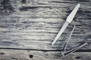 Nail clipper on wood background