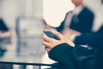 close up. businessman with a smartphone sitting at an office Des