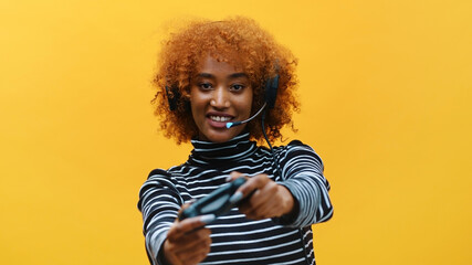 Black woman with headset professional gamer playing video games using joystick . High quality photo © CameraCraft