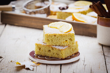 Portion  of orange cake with spice  on wooden table.
