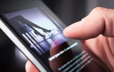 Man watching erotic video or looking at sexy photo with phone. Sex shop or online porn website. Person reading news article about sexual topic. Escort business, strip show or adult content on internet © terovesalainen