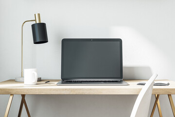 Comfortable workplace with laptop on table in home office.