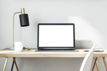 Contemporary office and laptop with blank screen