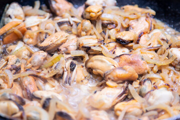 Mussels without shell slices in white ceramic bowl. Seafood concept. Selective focus. Space for text