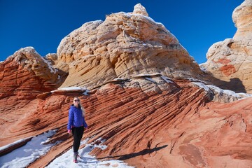 Woman on colorful rock. White Pocket Canyon. Vermillion Cliffs National Monument. Arizona. USA 