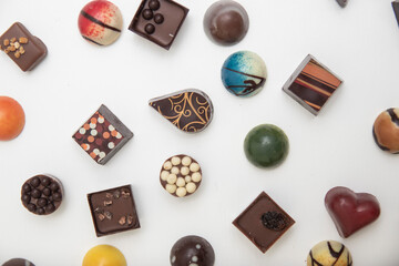 lot of variety chocolate pralines, top view of various chocolate pralines isolated on white background