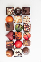 lot of variety chocolate pralines, top view of various chocolate pralines isolated on white background