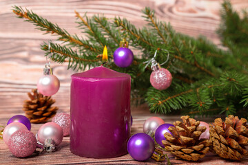 Obraz na płótnie Canvas Christmas tree baubles and burning candle