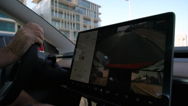 Man driving Tesla car in the city