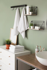 Fototapeta na wymiar Modern interior of stylish bathroom with towels on hooks