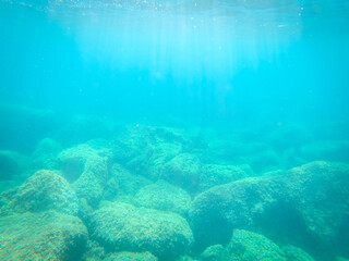 Underwater view of rocks and turquoise water in Alghero shore