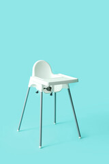Baby highchair on color background