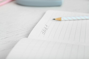 Notebook with written figure 2021 and pencil on table, closeup