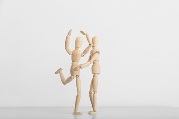 Wooden mannequins on light background