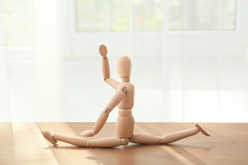 Wooden mannequin on table in room