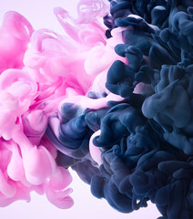 Abstract watercolor paint in water over pink